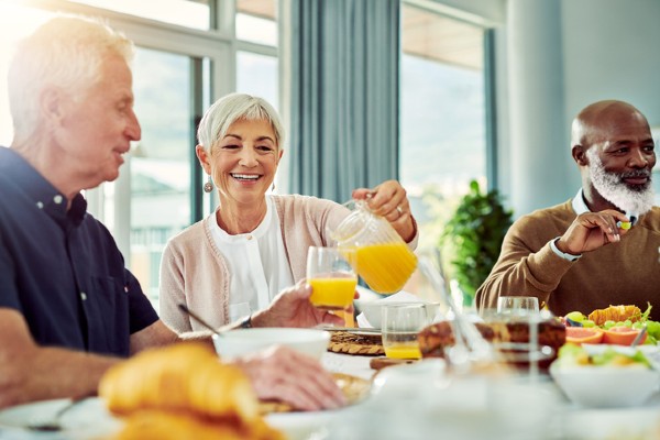 A group of retirees share a breakfast at a senior community.