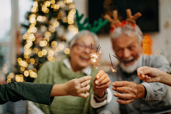 Seniors light sparklers during a Christmas celebration.