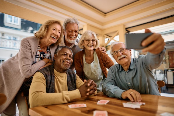 A group of happy senior people taking a selfie with their cellphone.