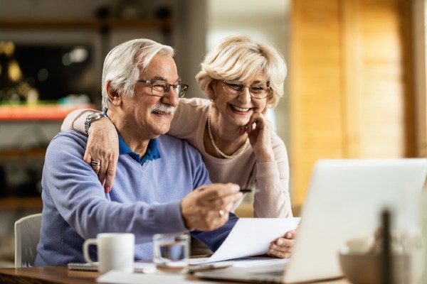 A senior couple fills out tax forms.